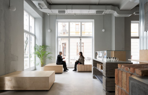 Bright window seating area inside Chernyi Cooperative Coffee Roasters in Belgrade
