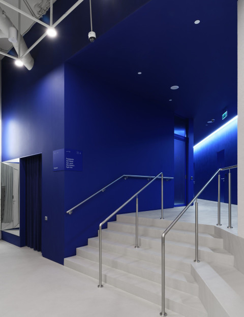 Vertical view of a futuristic corridor and lighting detail inside Gate-X Fitness Club