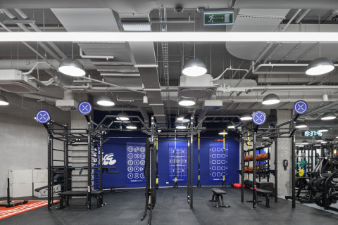 Wide shower area at Gate-X Fitness Club with deep blue ceiling and focused downlights