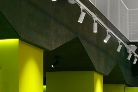 Jungle-like room inside Panteric with plant-filled structures and display shelves