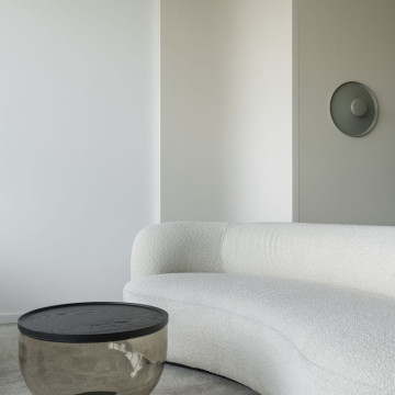 Curved sofa and smoked glass coffee table in a private office lounge