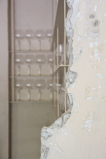 Stories restaurant interior with layered beige bar counter and globe lighting