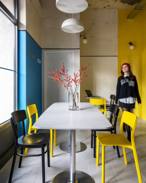 Cafe table and seating detail in the colorful TT-Eatery interior